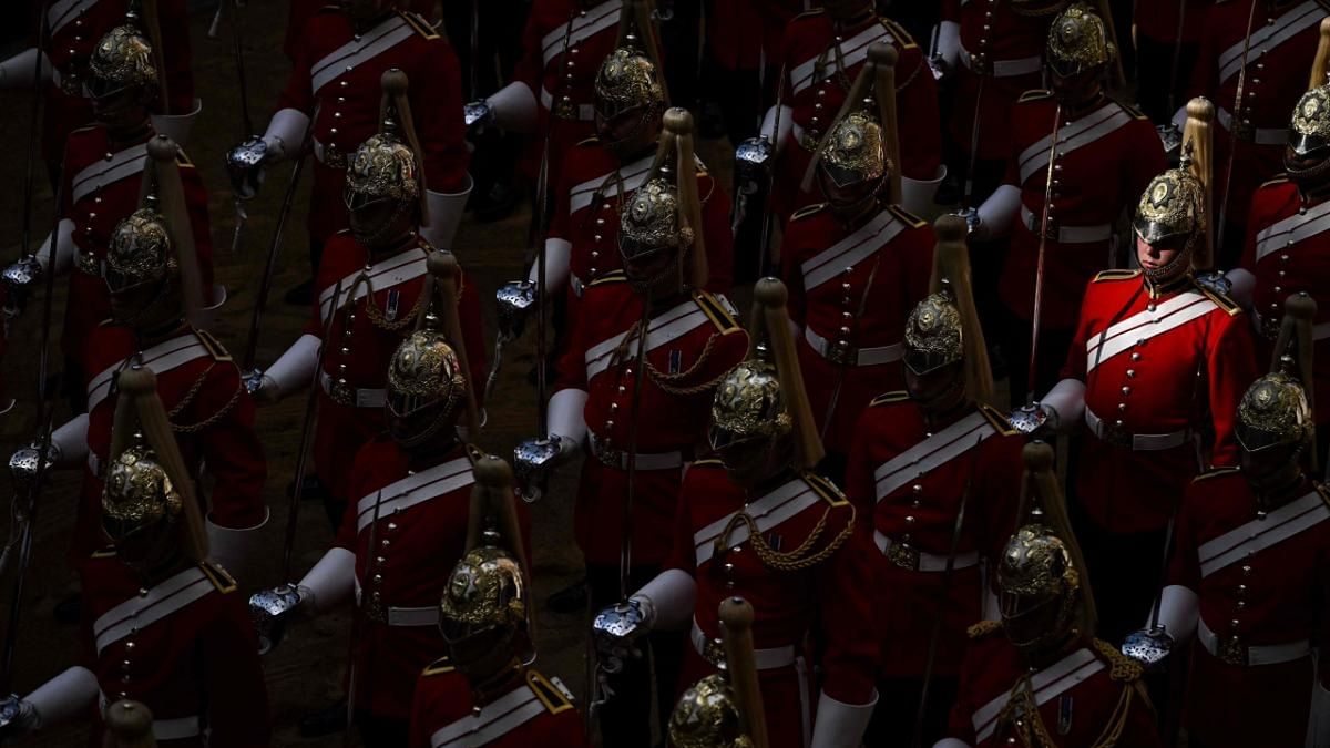 Life Guards, a unit of the Household Cavalry, stand guard outside the Palace of Westminster, following the procession of he coffin of Queen Elizabeth II from Buckingham Palace, in London. Credit: AFP Photo