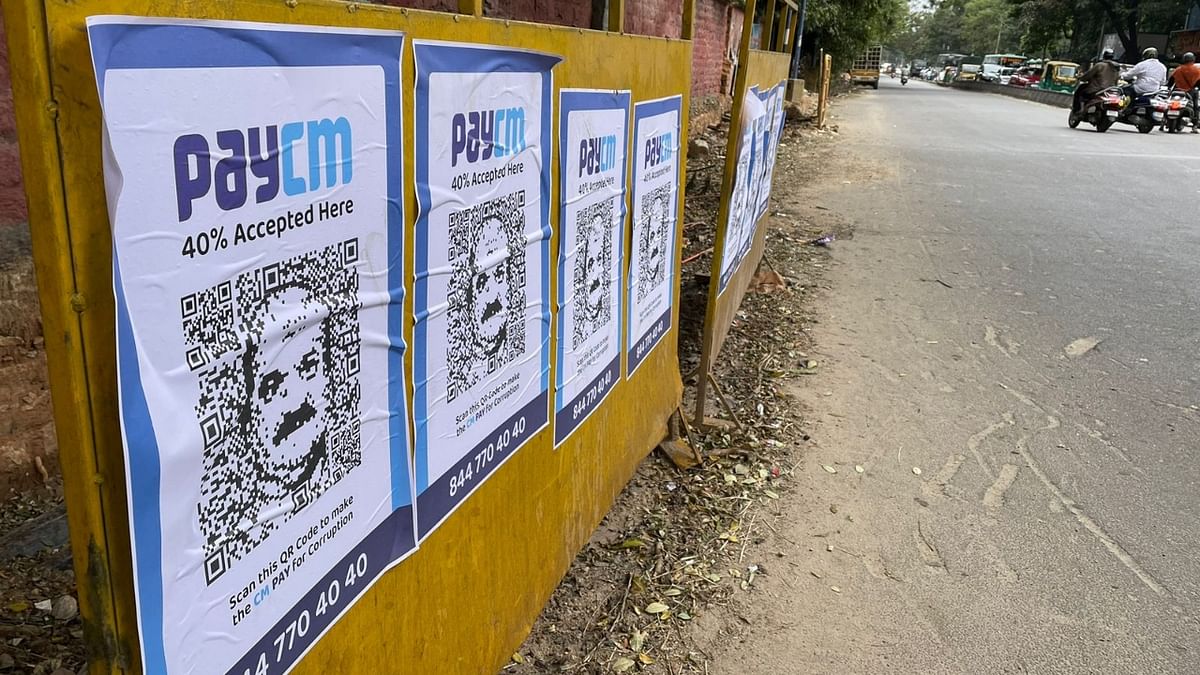 'PayCM' posters with Chief Minister Basavaraj Bommai's face along with a QR code have been put in Bengaluru. Credit: Pushkar V/DH Photo