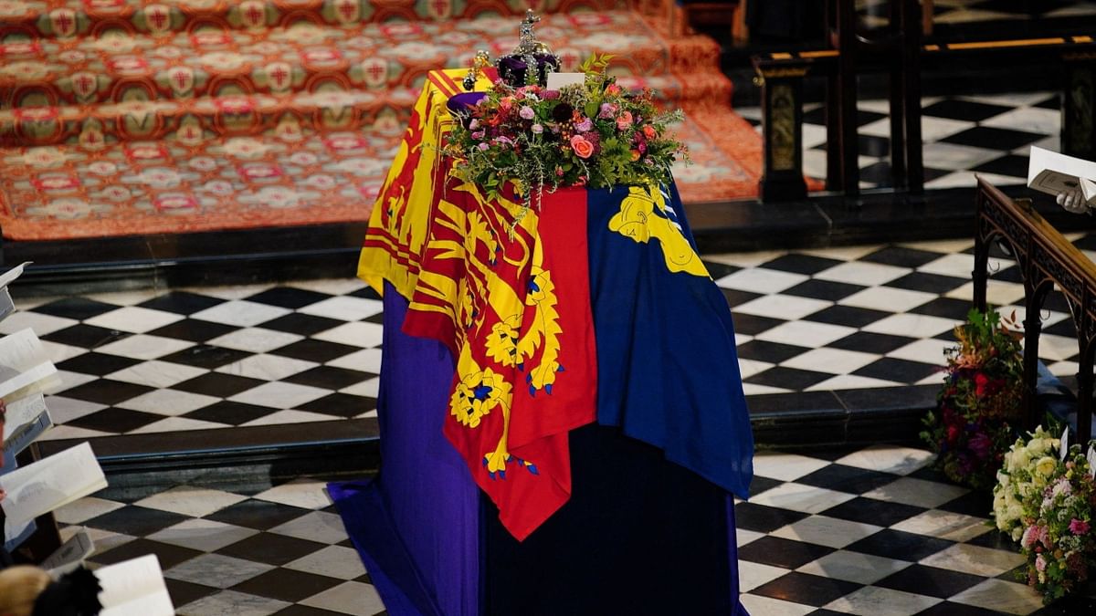 The Queen’s flag-draped coffin was lowered into the royal vault underneath the chapel, joining her father George VI and her husband, the Duke of Edinburgh. Credit: AFP Photo