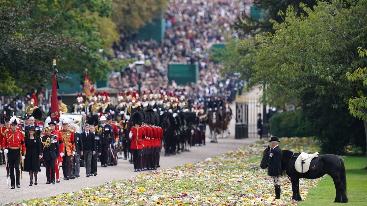 Thousands lined the streets on the route of this final procession, which Buckingham Palace said had been drawn up with the public in mind, and the Order of Service for the Committal Service was discussed with the late monarch 'over a number of years'. Credit: AFP Photo