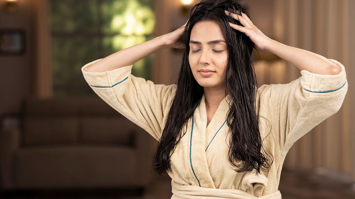 Monsoons can cause excessive humidity and sweating, which can harm your crowning glory by causing hair breakage and scalp infections. By massaging your hair with oil, you can prevent hair loss and nourish the roots. Credit: Getty Images