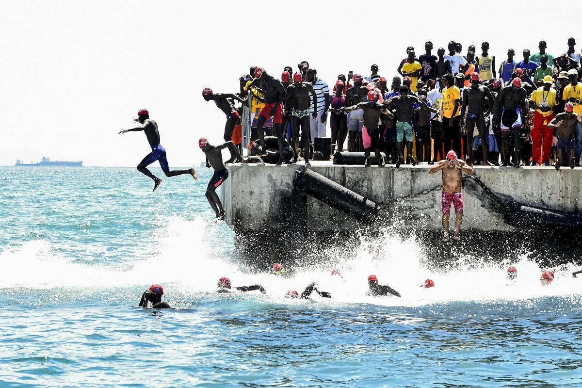 Competitors take the start of the circuit A of the swimming race from Dakar to Goree. Credit: AFP Photo