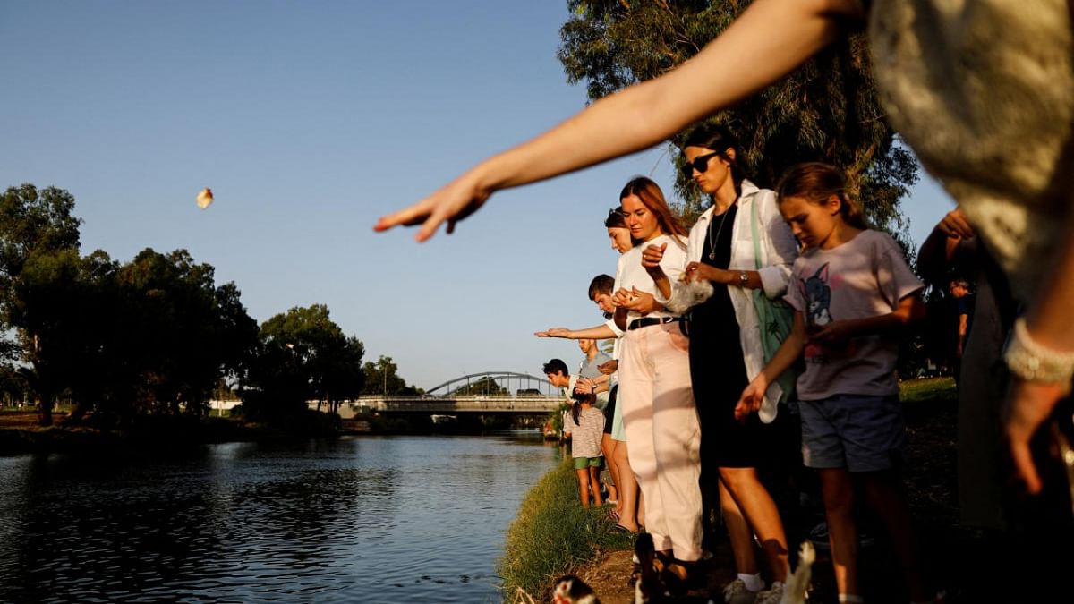 Jews perform a Tashlich ceremony, whereby they symbolically cast away their sins, on a Rosh Hashanah afternoon, the Jewish New Year, by the Yarkon river in Tel Aviv. Credit: Reuters photo