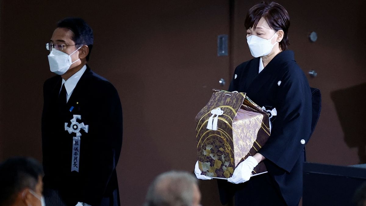 The ceremony started at 2 pm local (0500 GMT) with Abe's ashes carried into the Nippon Budokan Hall in central Tokyo by his widow, Akie, to music from a military band and the booms of the honour-guard salute. Credit: Reuters Photo
