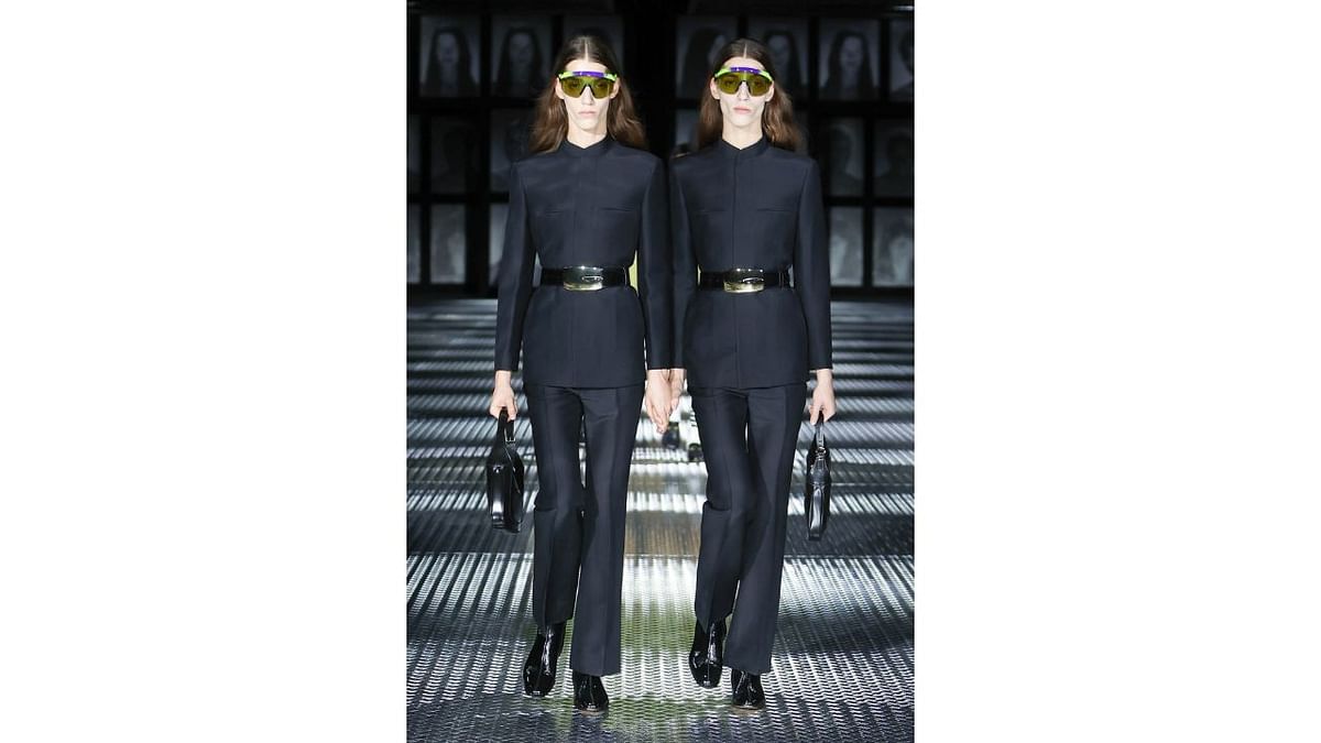 A pair of twins walk the ramp in matching outfits during the show 'Twinsburg' by Gucci at the Milan Fashion Week. Credit: Gucci/Facebook