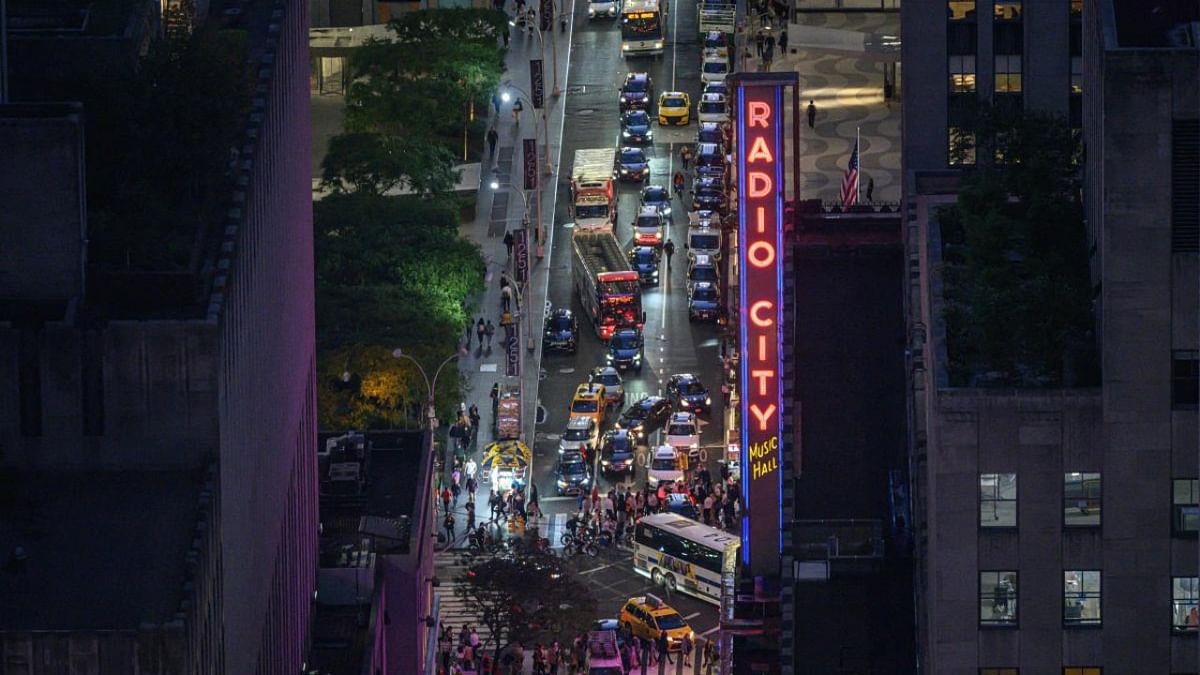 Traffic makes its way past Radio City along a cross-street in Manhattan, New York City. Credit: AFP Photo
