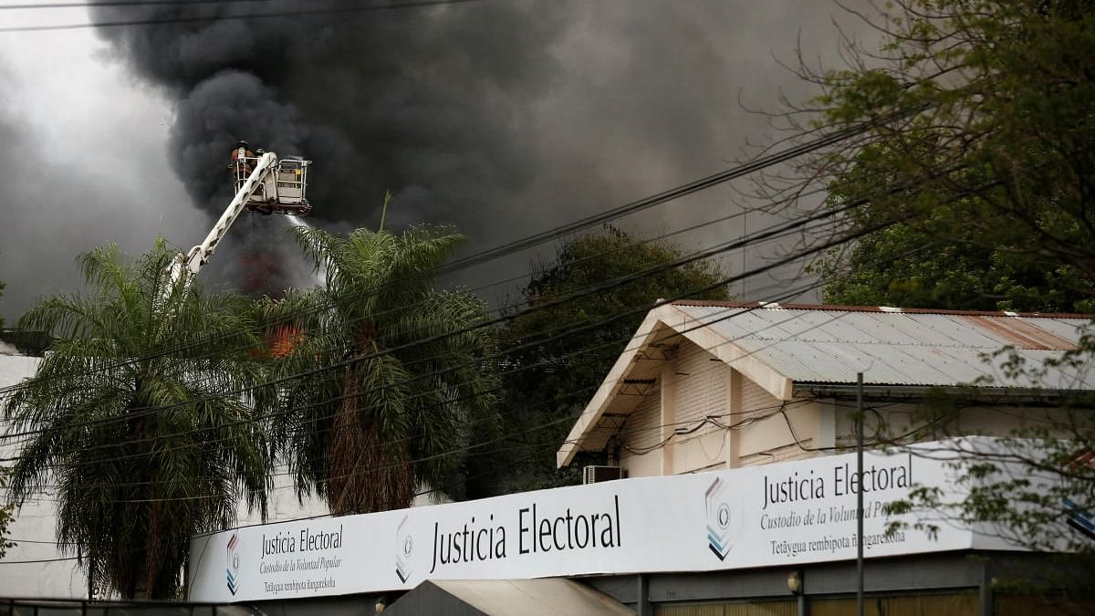Firefighters work to extinguish a fire at the headquarters of Paraguay's Superior Court of Electoral Justice (TSJE), in Asuncion, Paraguay. Credit: Reuters photo