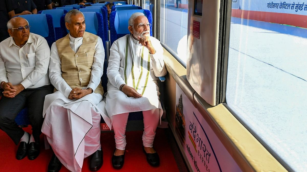 PM Modi travels with Gujarat Governor Acharya Devvrat and Gujarat CM Bhupendra Patel at the Gandhinagar-Mumbai Vande Bharat Express train in Gandhinagar. Credit: PTI Photo