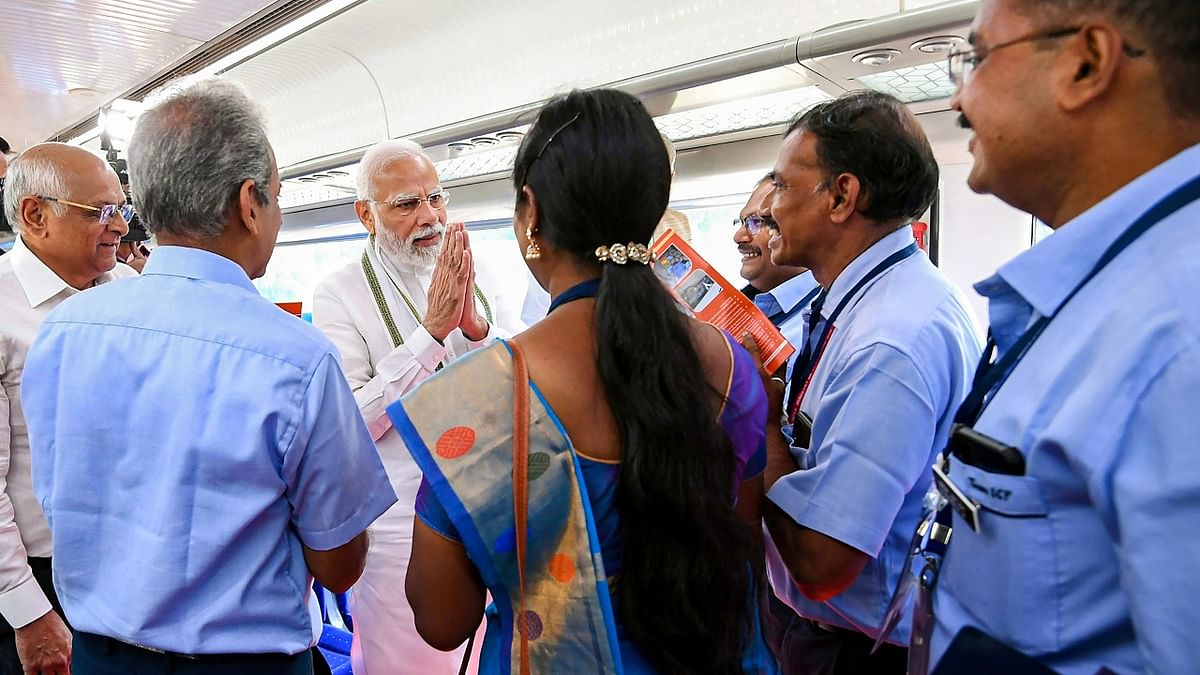 PM Narendra Modi interacts with the staff of the Gandhinagar-Mumbai Vande Bharat Express train, in Gandhinagar. Credit: PTI Photo