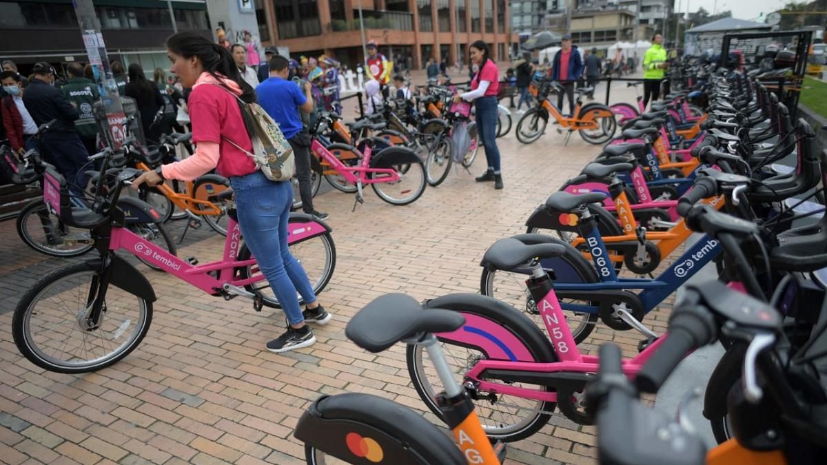 People prepare to ride shared bicycles during the launch of the first shared bike system in Bogota. Credit: AFP Photo