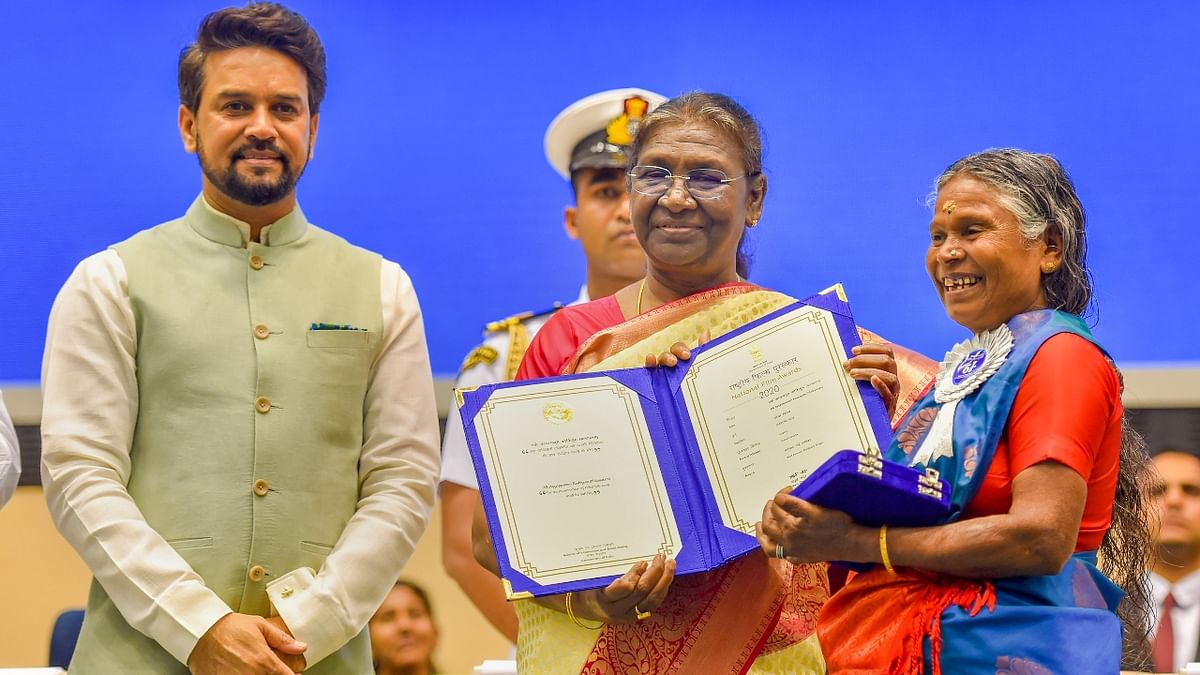 President Droupadi Murmu presents Best Female Playback Singer Award to Keralite tribal folk singer Nanjiyamma during the 68th National Film Awards presentation ceremony. Credit: PTI Photo