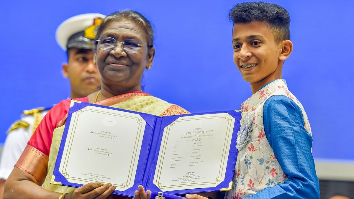President Droupadi Murmu presents Best Child Artist Award to Divyesh Shailendra Indulkar during the 68th National Film Awards presentation ceremony. Credit: PTI Photo