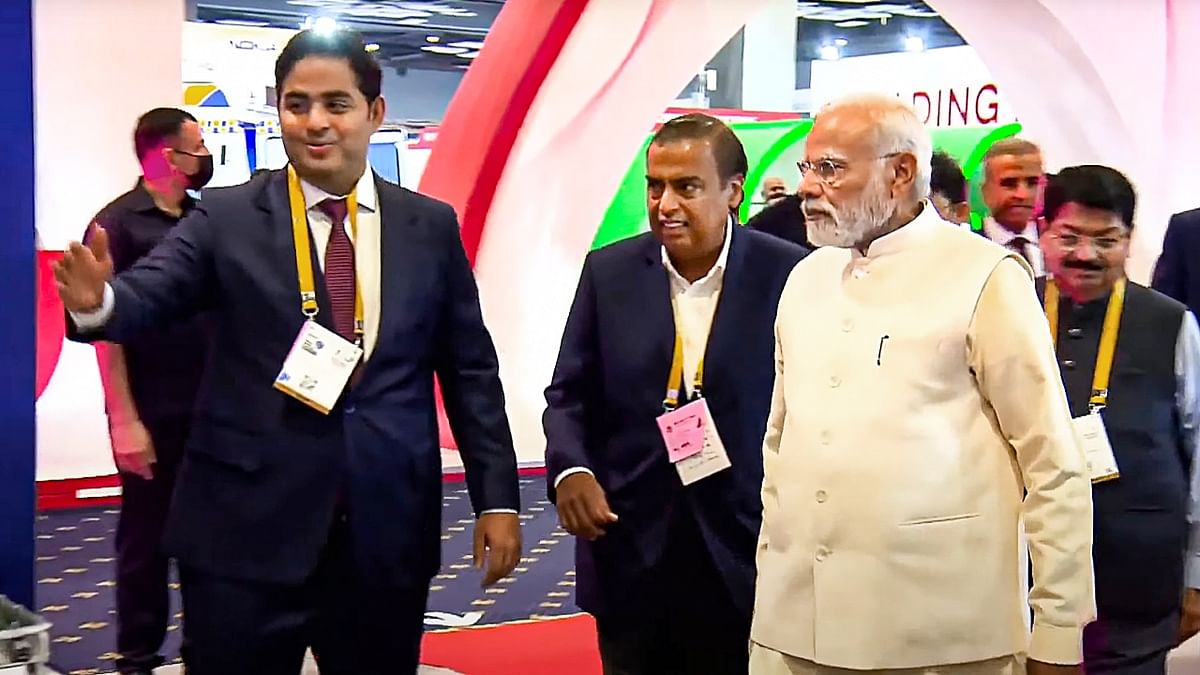 PM Modi interacts with RIL Chairman Mukesh Ambani and RJIL Chairman Akash Ambani during his visit to Jio Pavilion during the IMC 2022 exhibition. Credit: PTI Photo
