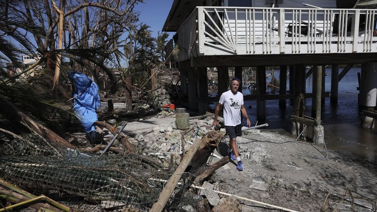 A resident walks through the wreckage left in the wake of Hurricane Ian on the island of Matlacha on September 30, 2022 in Matlacha, Florida. Credit: AFP Photo