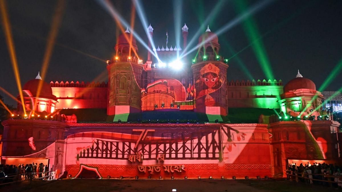 Long queues of pandal hoppers, from children to the aged, in new clothes, were seen at the more popular Durga Puja marquees across the city. This photo shows a replica of the Red Fort built as part of Durga Puja celebrations, in Kolkata. Credit: PTI Photo