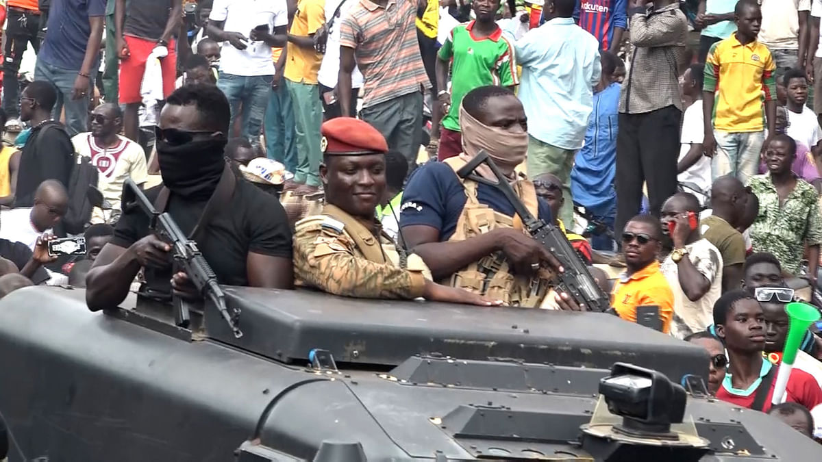 In this video grab taken from a footage of AFPTV the new self-proclaimed leader of the military junta ruling Burkina Faso, Captain Ibrahim Traoré (C), parades in the streets of Ouagadougou and hails the cheering crowd on October 2, 2022. Credit: AFP Photo