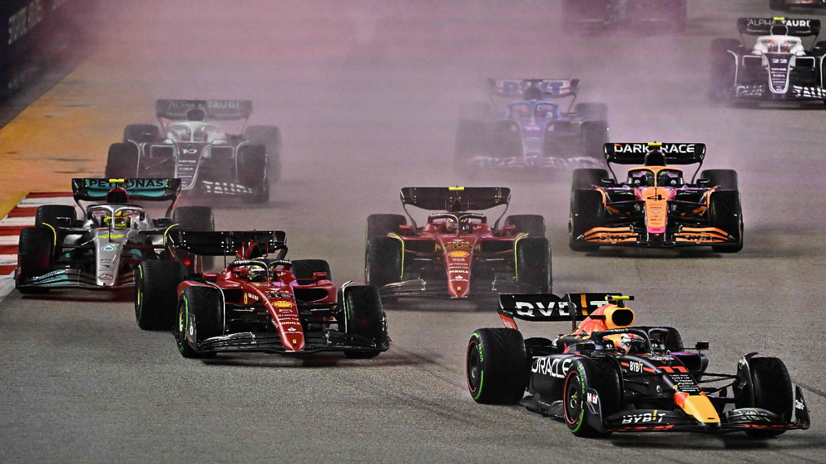Red Bull Racing's Mexican driver Sergio Perez (R) leads at the start of the Formula One Singapore Grand Prix night race at the Marina Bay Street Circuit in Singapore on October 2, 2022. Credit: AFP Photo
