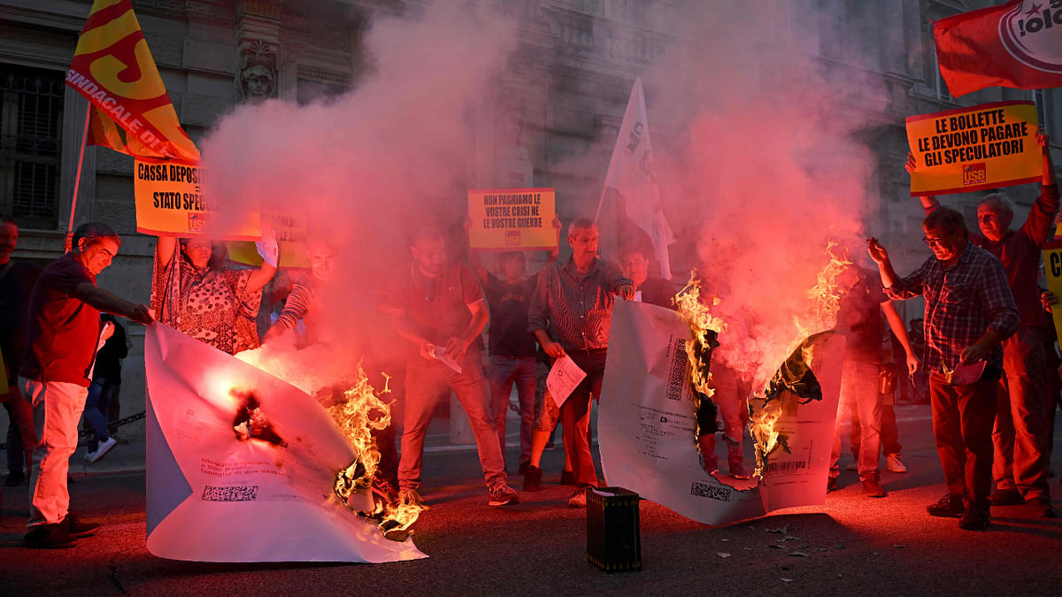 Protestors burn up their energy bills during a demonstration organized by Italian's Unione Sindacale di Base (USB) against the high cost of living and energy price rising in Rome on October 3, 2022. Credit: AFP Photo