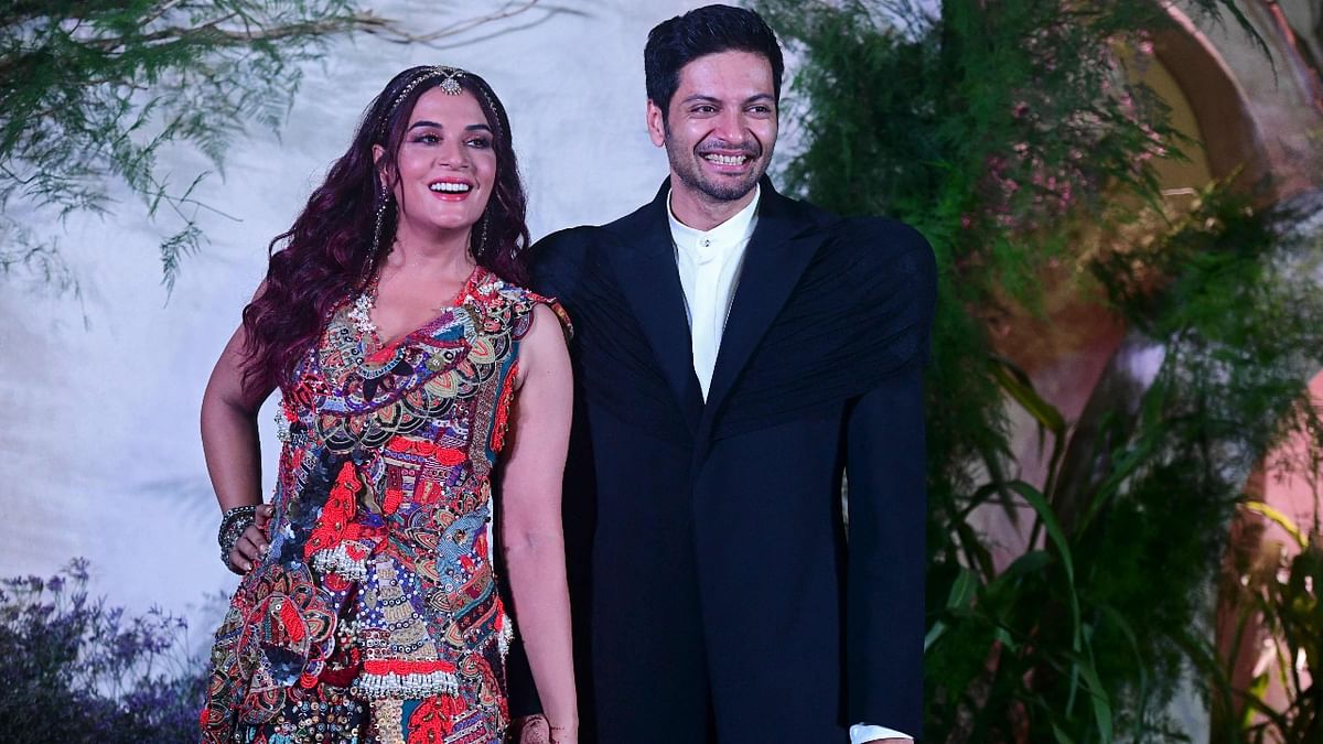 Ali Fazal and Richa Chadha wore designer outfits for the reception. While the bride Richa wore a colourful handcrafted gown from Anamika Khanna, Ali was seen in an Indo-Western suit designed by Kaushik Velendra. Credit: AFP Photo