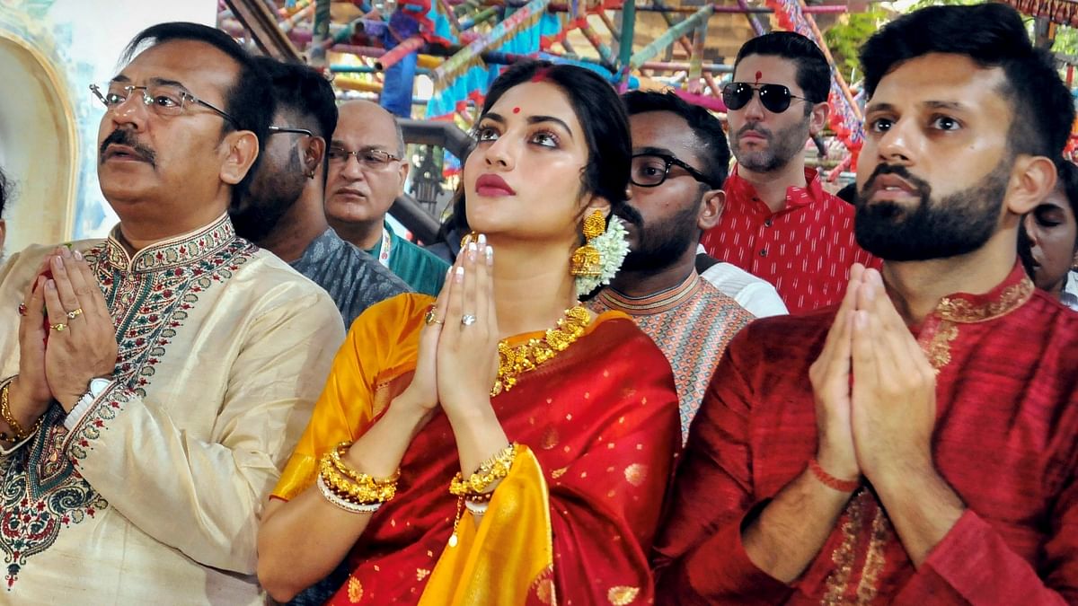 Actor-turned-politician Nusrat Jahan and her husband Nikhil Jain participated in 'Pushpanjali' offering rituals on 'Maha Ashtami' during the ongoing Durga Puja festival in Kolkata. Credit: PTI Photo