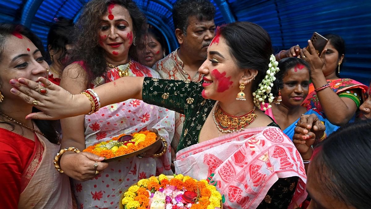 Manabi Bandyopadhyay and Bangladesh's actress Apu Biswas take part in the Sindoor Khela ritual on the final day of the Durga Puja festival in Kolkata. Credit: AFP Photo