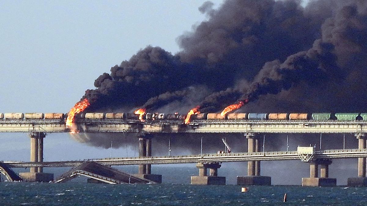 Smoke billows from a fire on the Kerch bridge that links Crimea to Russia, after a truck exploded on Saturday, igniting a huge fire and damaging the key bridge built as Russia's sole land link with annexed Crimea and vowed to find the perpetrators, without immediately blaming Ukraine. Credit: AFP Photo