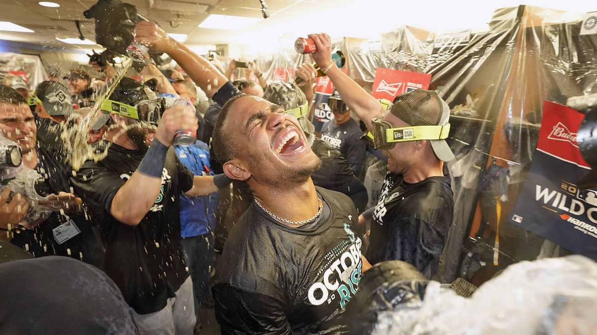 Julio Rodriguez #44 of the Seattle Mariners celebrates with the team in the locker room after defeating the Toronto Blue Jays in game two to win the American League Wild Card Series at Rogers Centre in Toronto, Ontario. Credit: AFP Photo