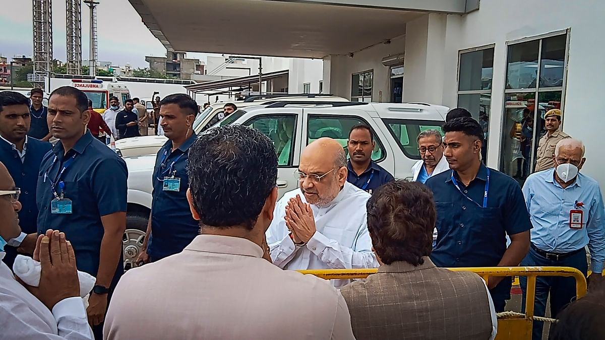 Union Home Minister Amit Shah greets the supporters of Samajwadi Party Supremo Mulayam Singh Yadav as he leaves after offering his last respects. Credit: PTI Photo