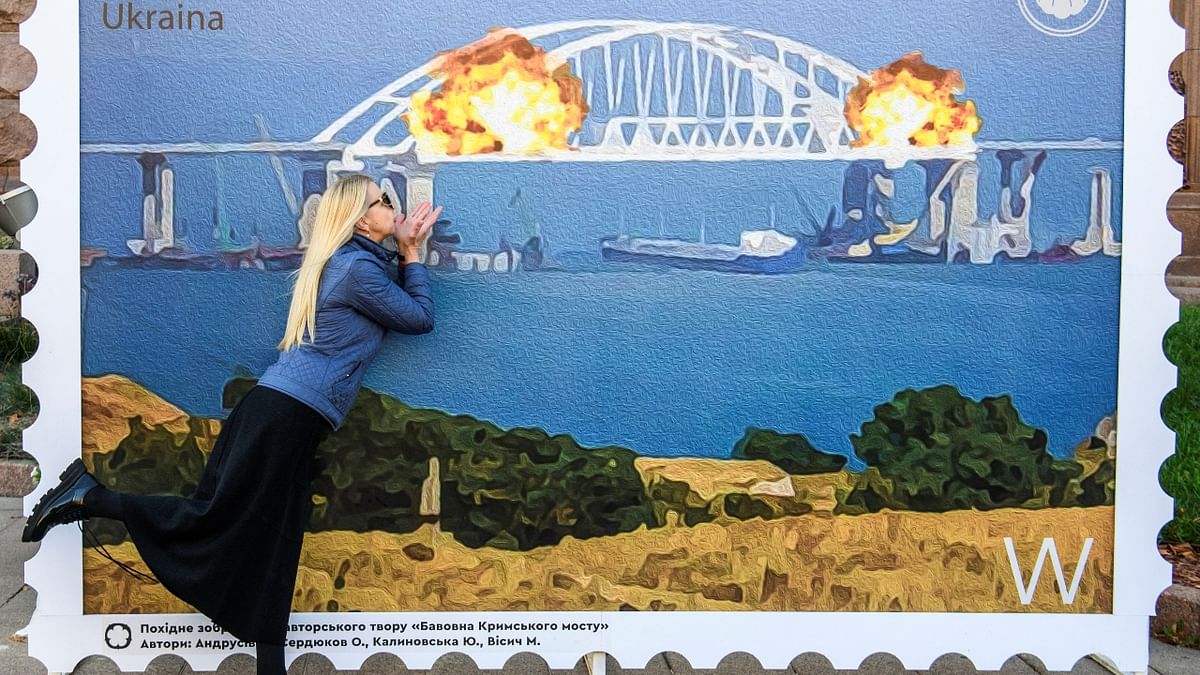 Another woman could be seen posing in front of the artwork, pretending to blow flying kisses at the blast. Credit: Reuters Photo