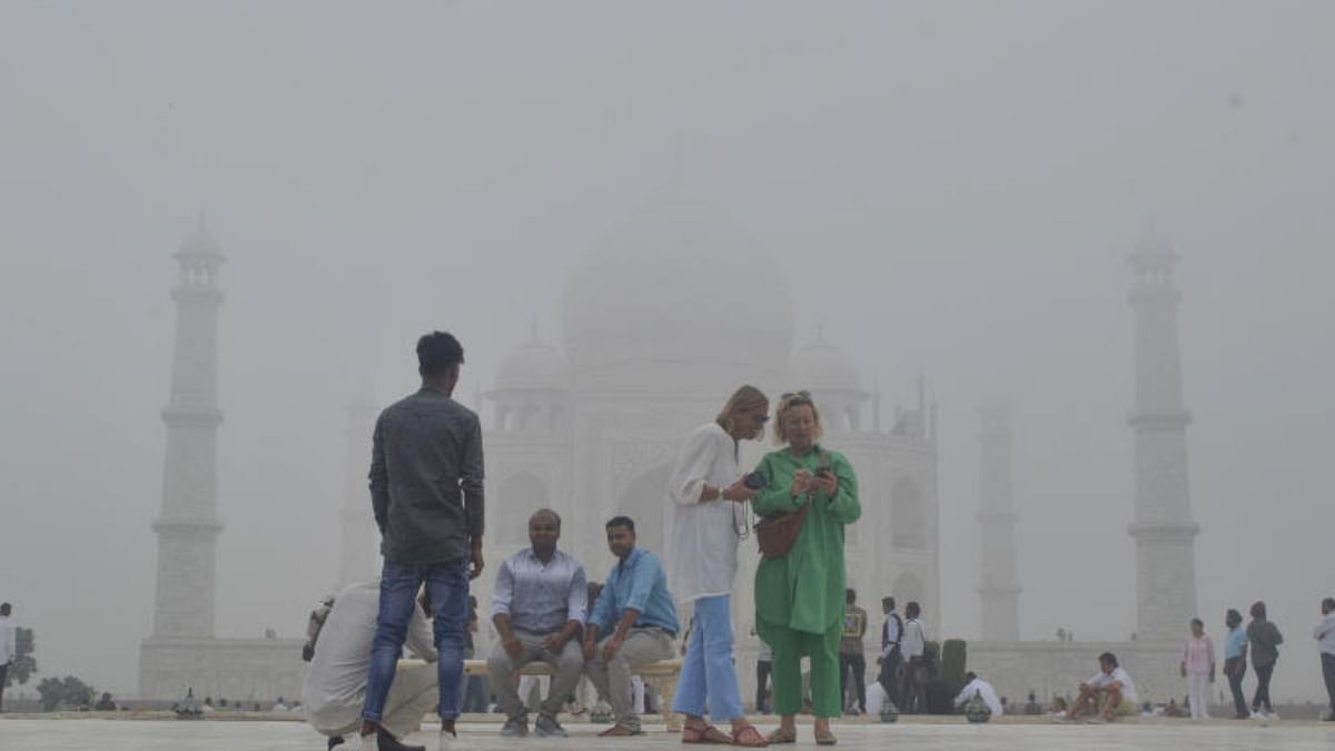 People visit the historic Taj Mahal shrouded in fog following rainfall over the last few days, in Agra, Wednesday, October 12, 2022. Credit: PTI Photo