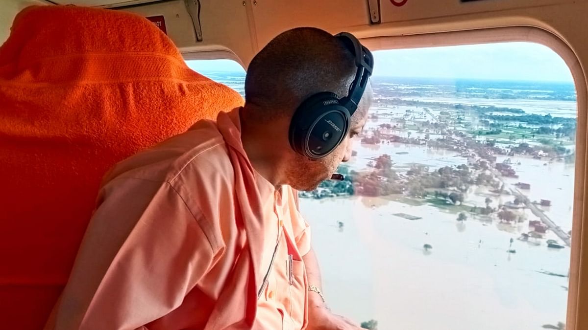 Uttar Pradesh Chief Minister Yogi Adityanath on his visit to the flood-affected areas in Maharajganj and Gorakhpur, distributed relief materials. Credit: PTI Photo