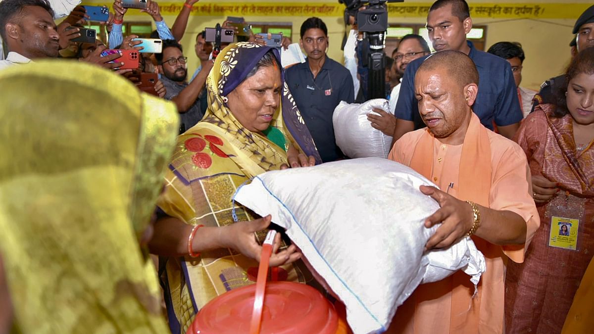 Uttar Pradesh Chief Minister Yogi Adityanath on his visit to Shravasti district distributed relief materials to the people affected by flood. Credit: PTI Photo