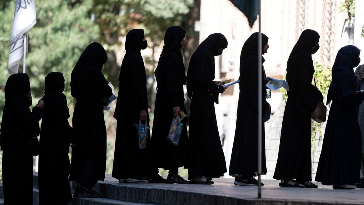 Afghan female students stand in a queue after they arrive for entrance exams at Kabul University in Kabul on October 13, 2022. Credit: AFP Photo