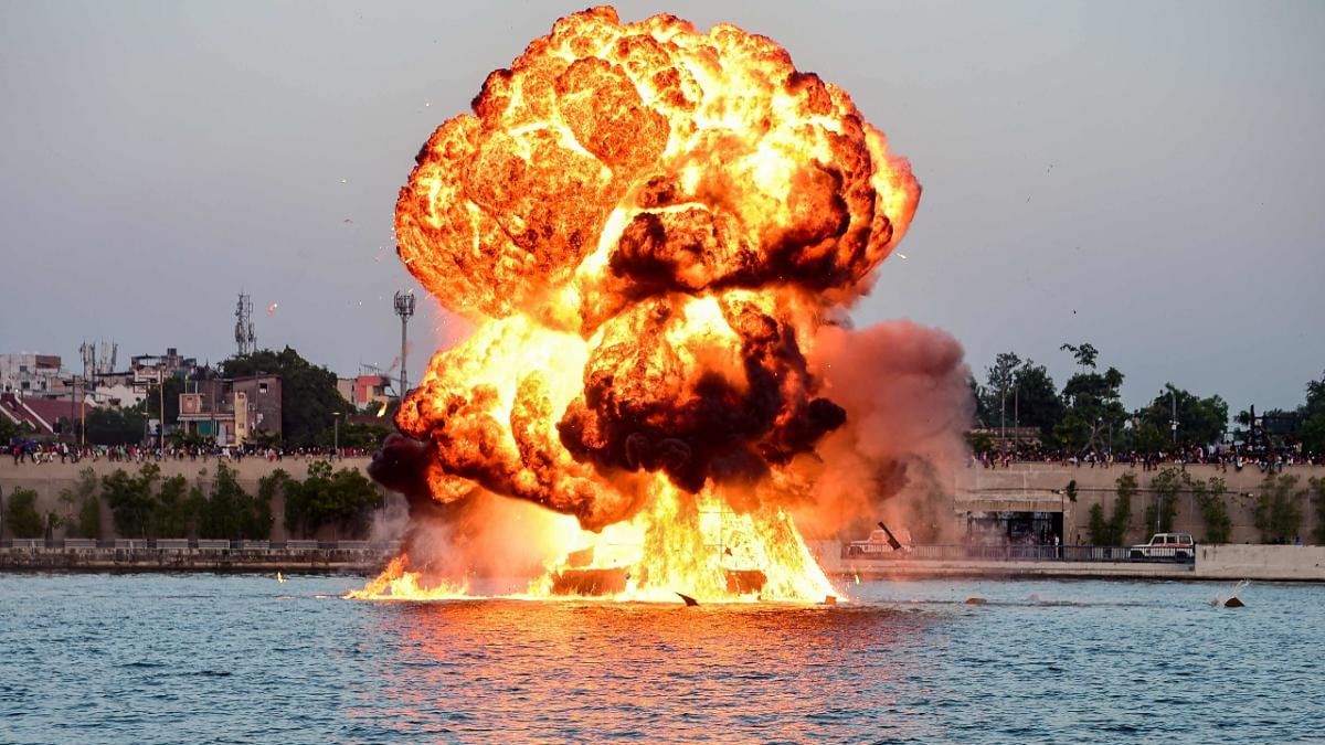 A dummy target is exploded by use of mines by Navy's divers, as a part of rehearsals for the upcoming defence equipment exhibition – Defence Expo 2022, at the Sabarmati Riverfront in Ahmedabad. Credit: AFP Photo