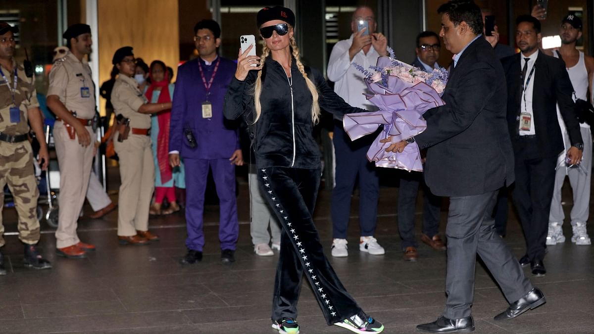 The hotel heiress was smitten by the love shown by her fans at the airport. In this photo, she is seen capturing the fans' reactions. Credit: Reuters Photo