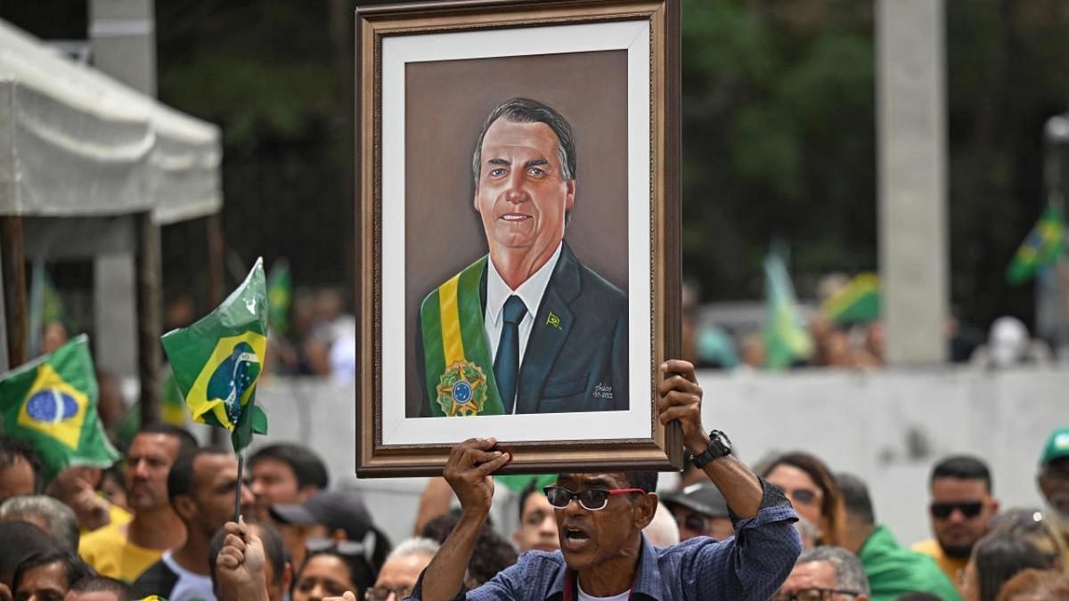 A supporter displays a painting depicting Brazil's president and re-election candidate Jair Bolsonaro during a campaign rally in Sao Goncalo, Rio de Janeiro, Brazil. Credit: AFP Photo