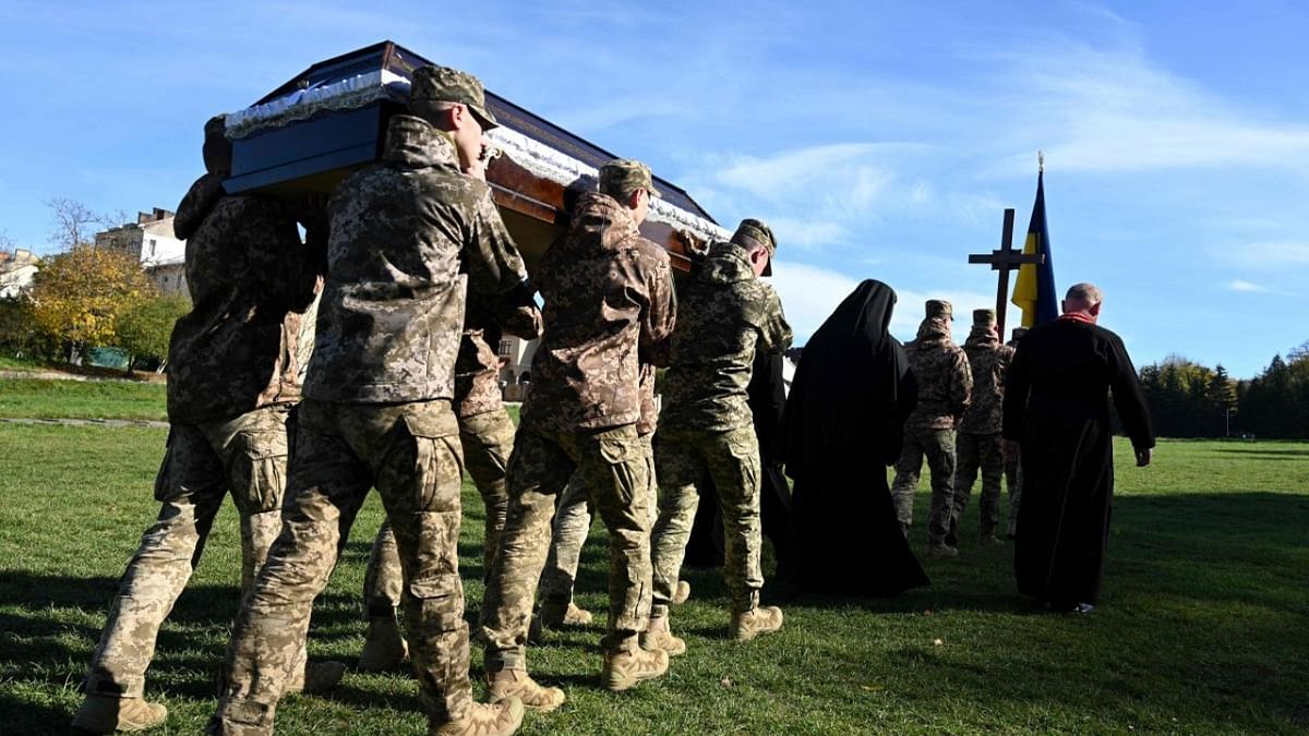 Soldiers carry one of coffins of Ukrainian servicemen Valery Khoroshev, Yuri Lenko, Maksym Moklovych and Nazariy Chygin, who died in the fighting with Russian troops in the Saints Peter and Paul Garrison Church during their funeral ceremony in Lviv. Credit: AFP Photo