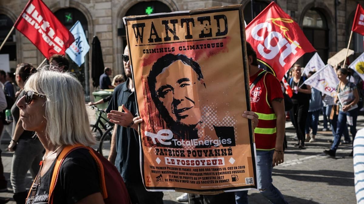 A man holds a 'wanted poster' depicting the head of TotalEnergie during a demonstration in the western city of Bordeaux. Credit: AFP Photo
