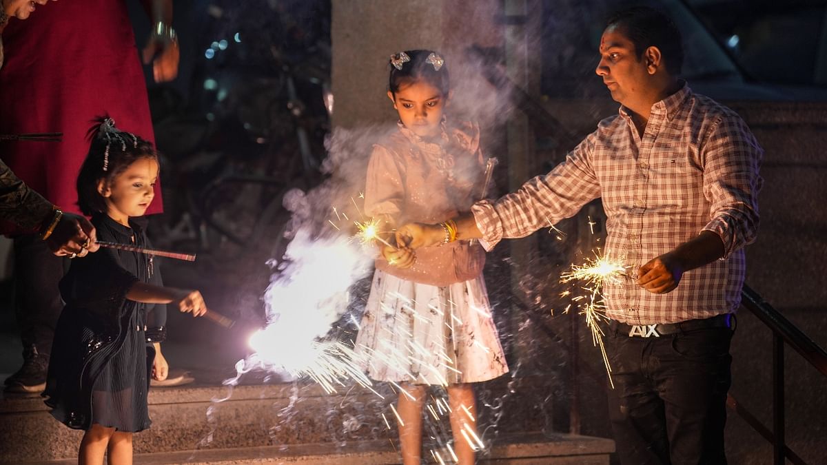 People burst firecrackers to celebrate Diwali festival in Delhi. Credit: PTI Photo