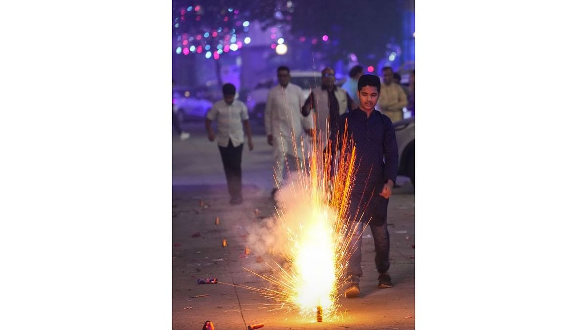People burst firecrackers to celebrate Diwali festival, in Delhi. Credit: PTI Photo