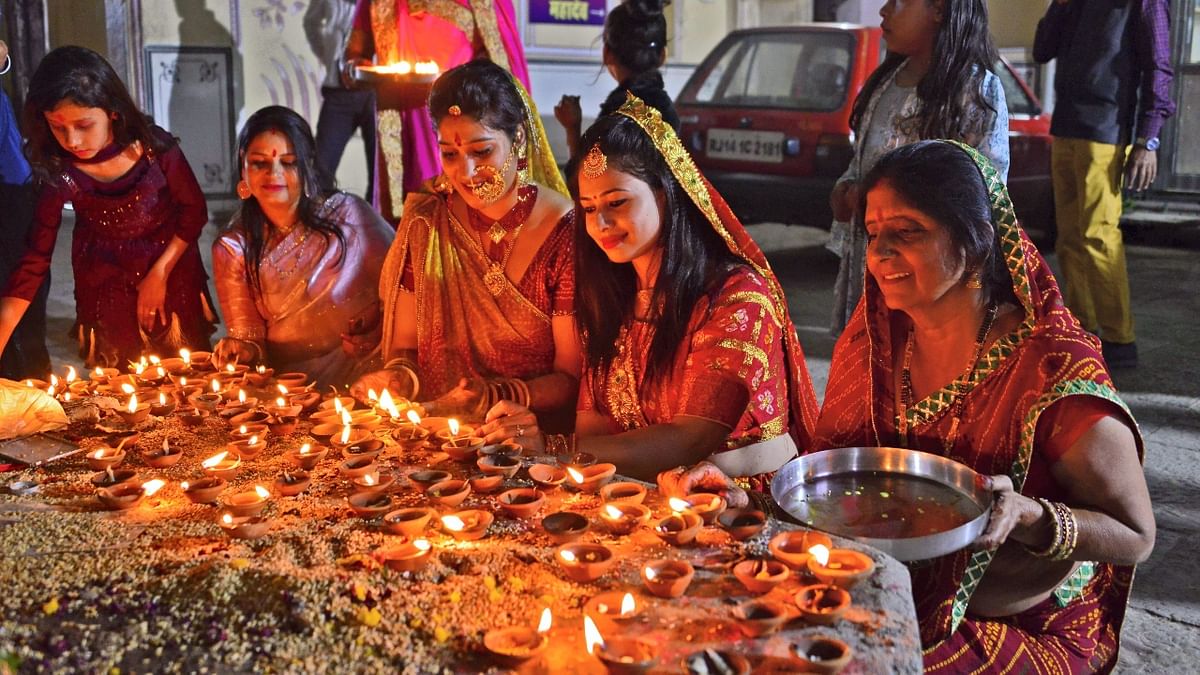 Devotees light earthen lamps at Ramchandra Ji temple on the occasion of Diwali in Jaipur. Credit: PTI Photo
