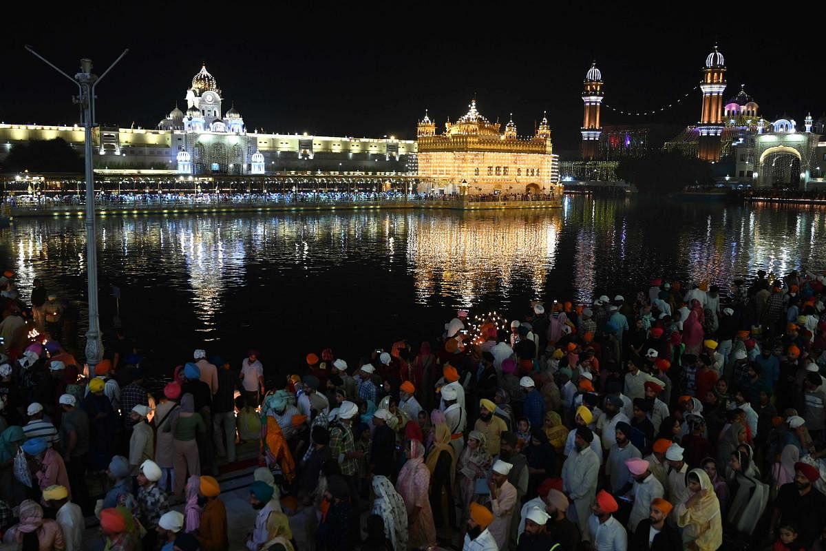 Devotees visit the illuminated Golden Temple on the occasion of Bandi Chhor Divas, a Sikh festival coinciding with Diwali, the Hindu festival of lights, in Amritsar. Credit: AFP Photo