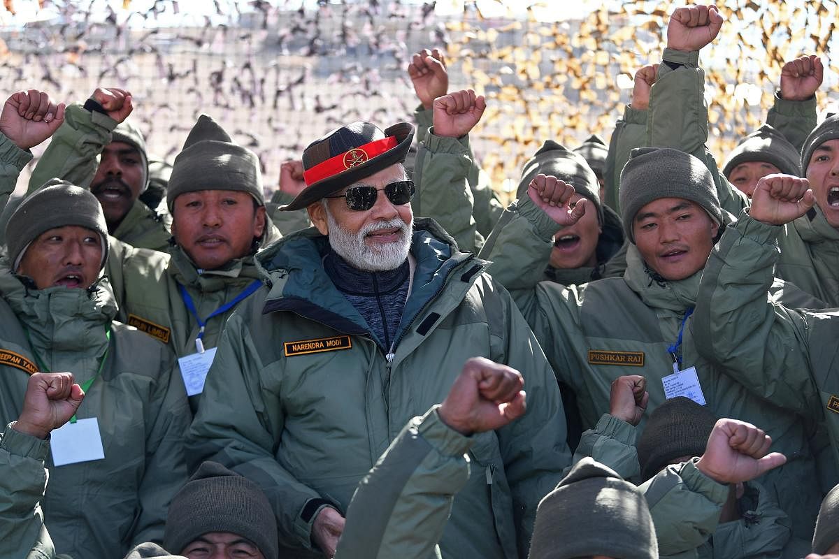 India's Prime Minister Narendra Modi (C) attending the celebrations with the members of Indian armed forces on the occasion of Diwali, the Hindu festival of lights, at Kargil. Credit: AFP Photo