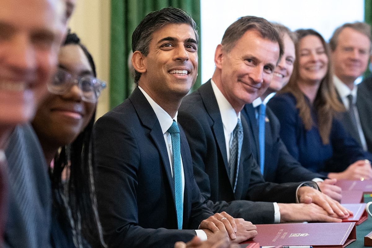 Britain's Prime Minister Rishi Sunak (C) poses for a photograph alongside Britain's Chancellor of the Exchequer Jeremy Hunt (centre right) and Britain's Secretary of State for International Trade, President of the Board of Trade and Minister for Women and Equalities Kemi Badenoch (centre left) at the first cabinet meeting under the new Prime Minister, Rishi Sunak in 10 Downing Street. Credit: AFP Photo