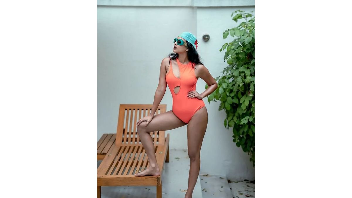 This stunning picture of Amala in an orange monokini by the pool is just the right amount of boho and chic. Credit: Instagram/amalapaul