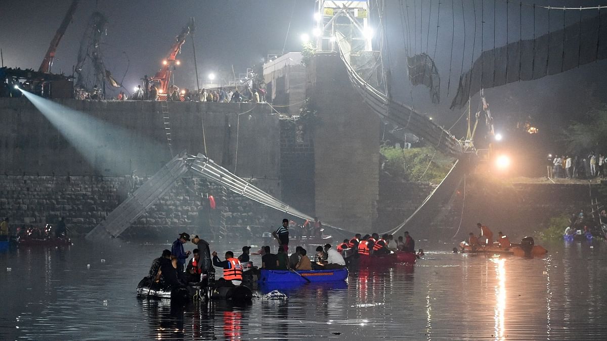 Eyewitnesses said there were several women and children on the British era “hanging bridge” when it snapped, plunging them into the river below. Credit: AFP Photo