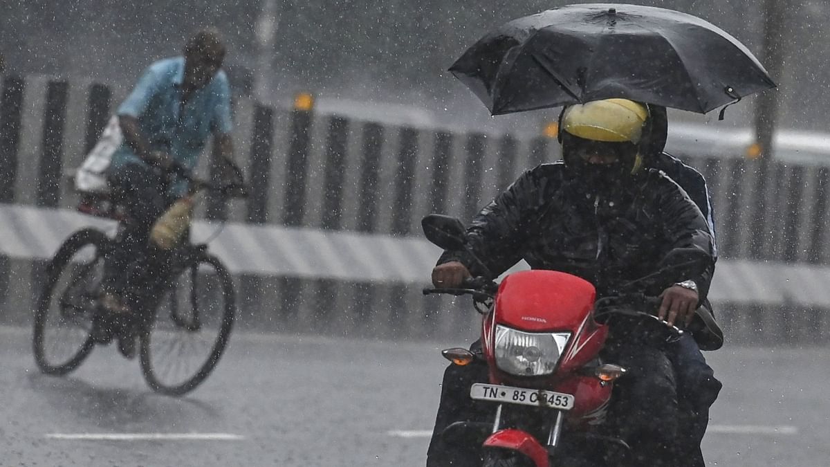 Motorists make their way along a street amid a heavy monsoon rainfall in Chennai. Credit: AFP Photo