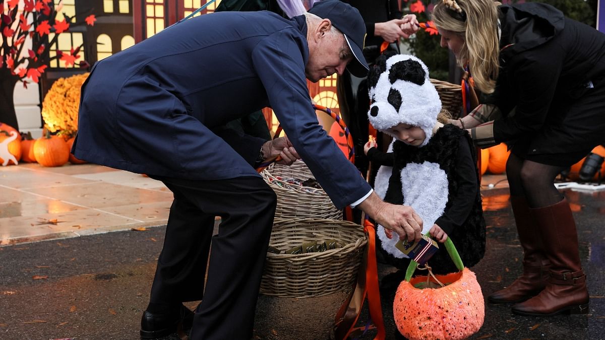 US President Joe Biden greeted a child during a Halloween party at the White House in Washington. Credit: Reuters Photo