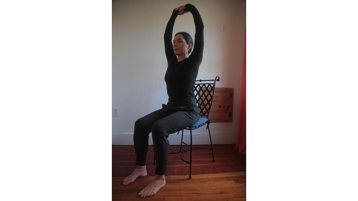 Sitting Tadasana | This posture will help you to relax the muscles of the arms and shoulders which get stiffed by working for long hours in front of a computer. Credit: www.yogauonline.com