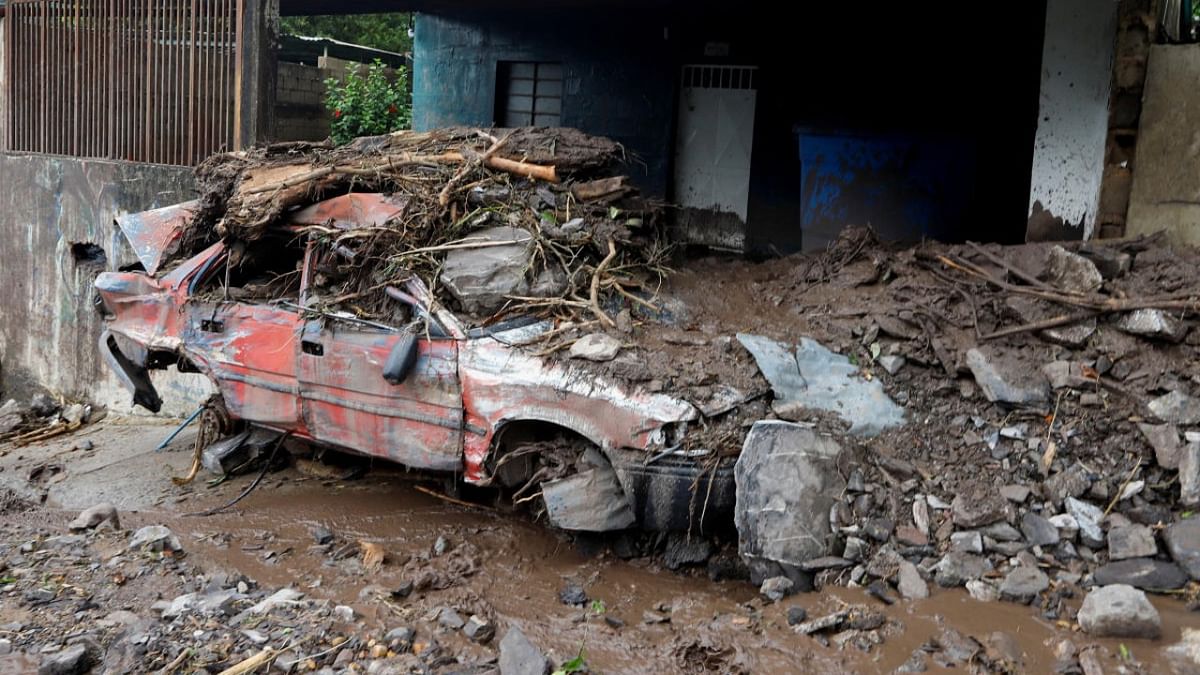 A damaged vehicle covered in mud is pictured in the aftermath of floods caused by heavy rain, in Puerto La Cruz, Venezuela. Credit: Reuters photo